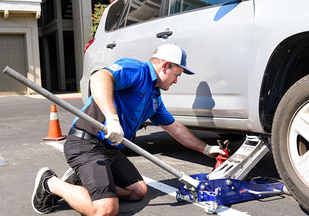 Gabe working on a repair with a jackstand